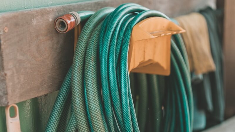 green and yellow hose on brown wooden table